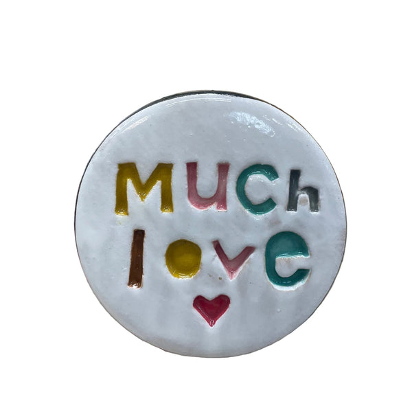 Ceramic disc with 'Much Love' text on a floral background
