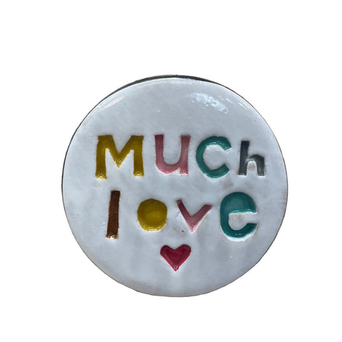 Ceramic disc with 'Much Love' text on a floral background