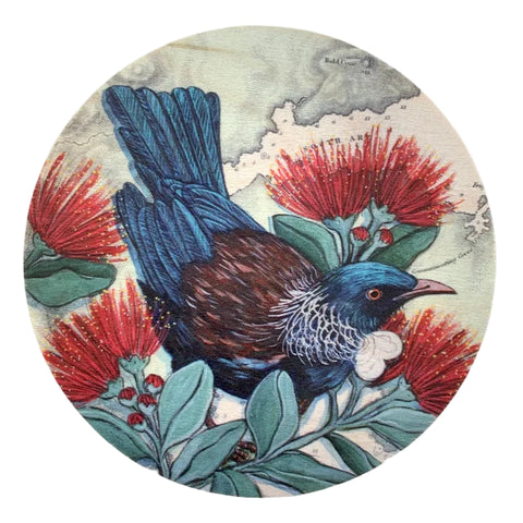 Round coaster with a bird and floral design on a white background